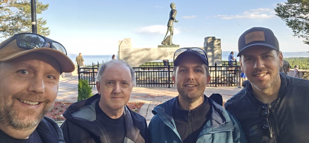 Four guys standing near the Terry Fox memorial in Thunder Bay, Ontario
