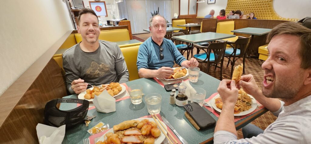 Three guys sitting at a table in a Chinese food restaurant