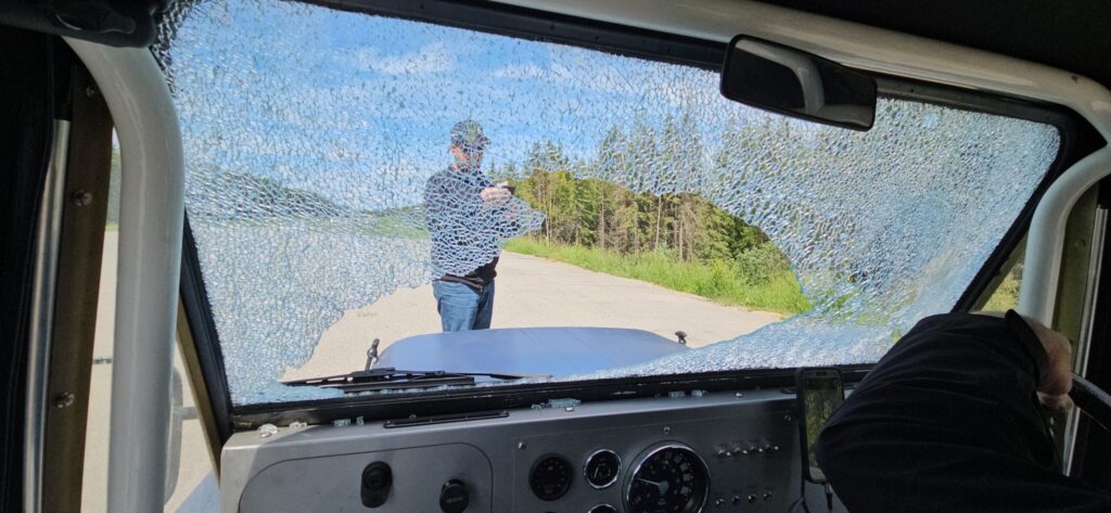 A picture of a broken windscreen from inside a Mini Moke