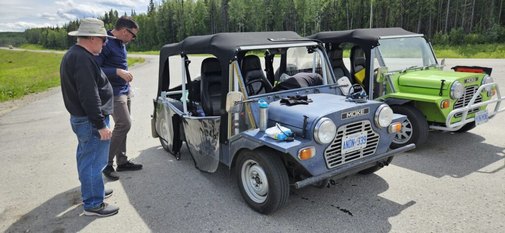 A picture of two Mini Mokes, one without a windshield