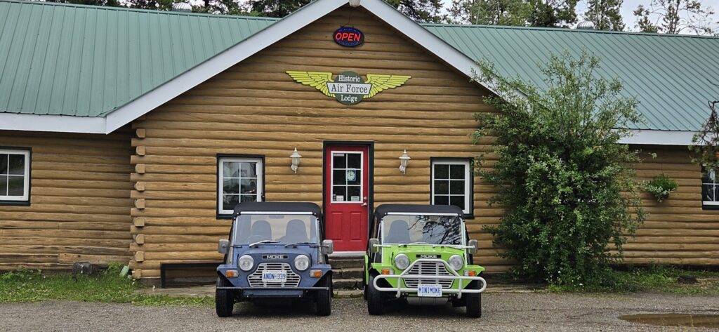 Two Mini Mokes sitting outside the Air Force Lodge in Watson Lake, YT